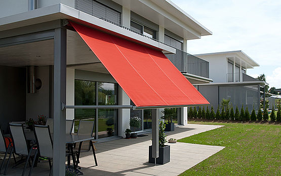 drop arm awning extending from house