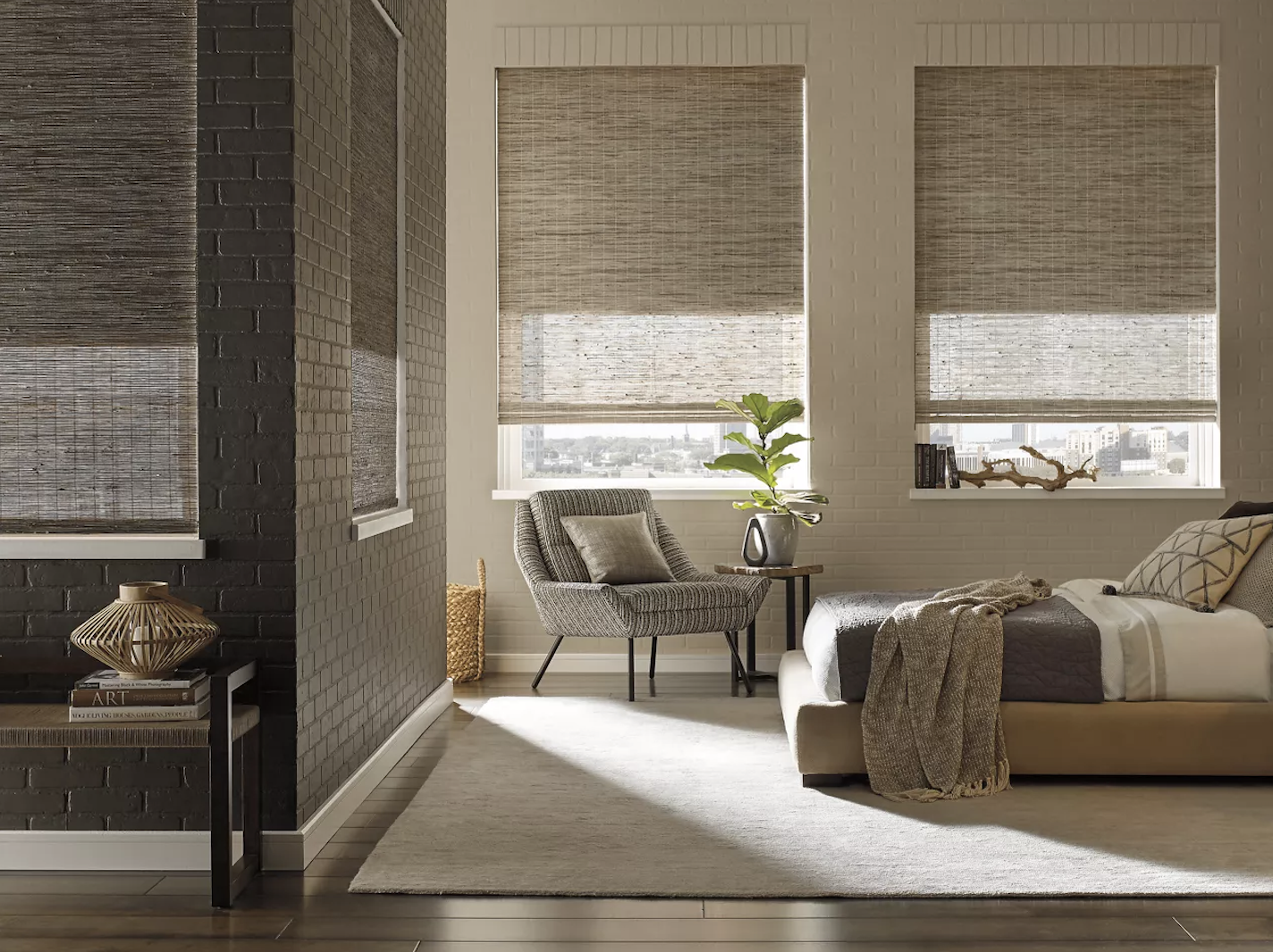 A bedroom decorated in earth tones with Hunter Douglas shades.