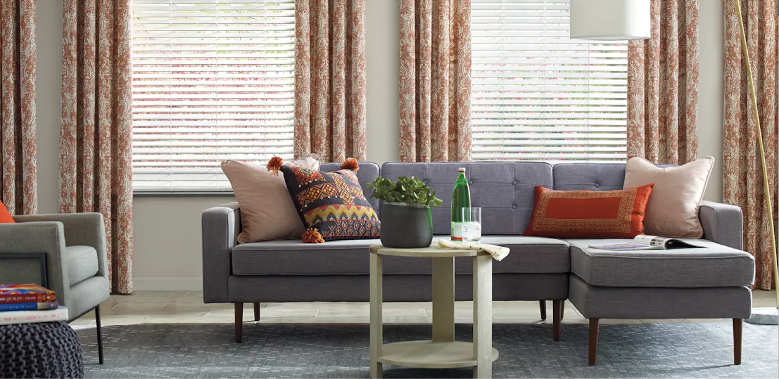 A living room with custom Hunter Douglas drapes. Colours match fall trends