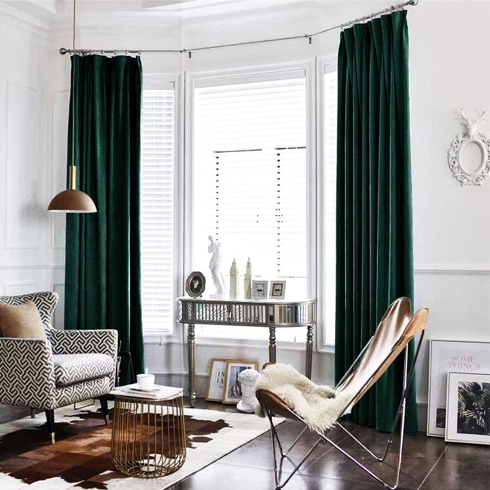 A living room with emerald green drapes on the windows suitable for fall