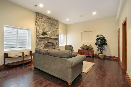 Brightly lit basement with fireplace